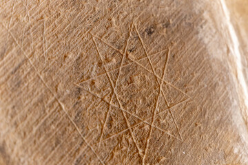 A sandstone surface with a star pattern drawn on it