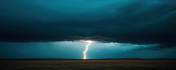 Obraz premium Lightning piercing dark clouds over a tranquil landscape, dramatic weather scene.