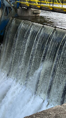 A dam on a river with water falling down. The Bobr River, Poland © PRO Balance