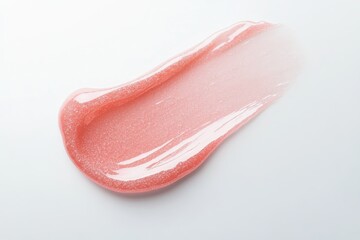 Pink shimmer lip gloss stroke on white background highlighting texture and elegance