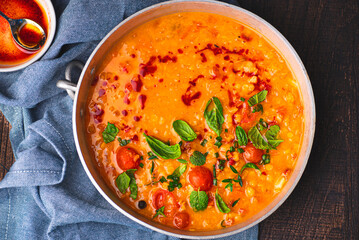 Turkish Red Lentil Soup (Kırmızı Mercimek Çorbası) with vegetables, tomatoes. mint, cumin and spicy olive oil. Mediterranean healthy recipes vegetarian cuisine