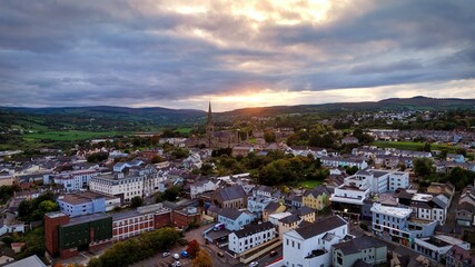 Obraz premium Aerial view over the town of Letterkenny in Ireland in the evening - a breathtaking scenic cityscape at dusk featuring a beautiful and cloudy sky