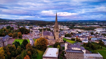 Obraz premium Aerial view over the town of Letterkenny in Ireland in the evening - a breathtaking scenic cityscape at dusk featuring a beautiful and cloudy sky