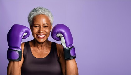 African American senior women wearing purple boxing glovesguard prtect pose isolated on the purple background