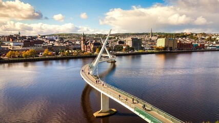 City of Derry aka Londonderry in Northern Ireland aerial view - A Dramatic Cityscape by the River Foyle Featuring a Beautiful Pedestrian Bridge