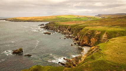 Malin Beg at the west coast of Ireland in Donegal - breathtaking coastal landscape that beautifully overlooks a rocky shoreline and the vast ocean