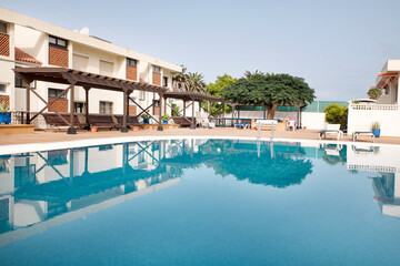 A well-maintained swimming pool within a private residential complex, situated in one of the most popular tourist areas at Vera Mar Beachfront Complex, Tenerife, Canary Islands, Spain