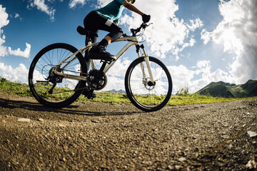 Fototapeta premium Woman riding mountain bike on mountain top trail