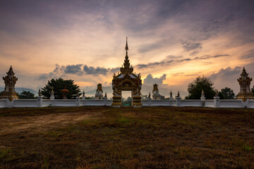 Wat Khao Sawan Thak is a Lanna-style temple at sunrise in Chanthaburi Province. It has beautiful architecture surrounded by nature.