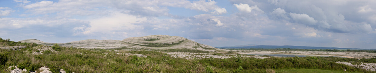 Super panorama of Burren National Park rugged terrain in Ireland, showing sweeping limestone...