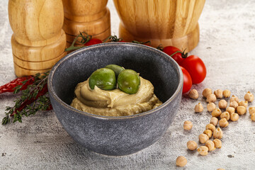 Tasty hummus with green olives