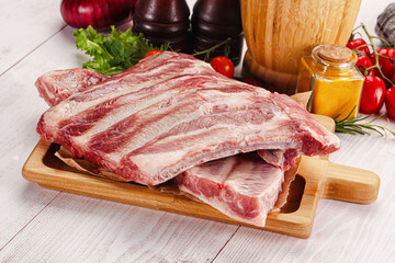 Raw pork ribs over board