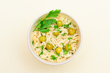 Prepared Instant Noodles with Green Pea and Greens on White Background - Top View. Quick Lunch or Unhealthy Fast Food