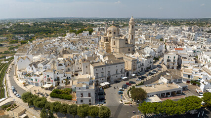 Fototapeta premium Aerial view of the historic center of Locorotondo, in the metropolitan city of Bari, Italy. It is located on a hill in the Itria Valley in Puglia.