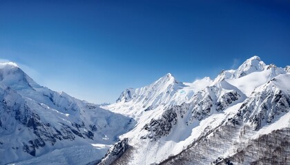 Obraz premium Snow-capped mountains with a crystal-clear blue sky, stunning winter landscape travel destinations beauty in nature