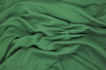 Abstract texture a wrinkled green  blanket