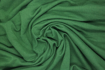 Abstract texture a wrinkled green  blanket