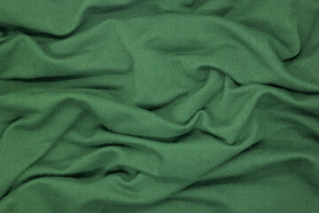 Abstract texture a wrinkled green  blanket