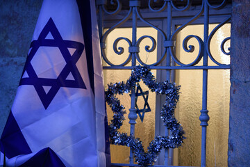 Israeli flag and silver tinsel Jewish star decorate a home in Jerusalem to mark the celebration of...