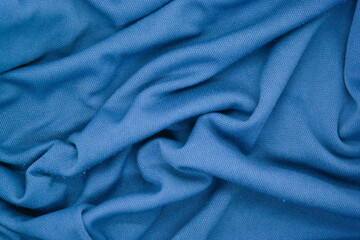 Abstract texture a wrinkled soft blue blanket