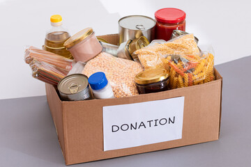 Donation Box of Free Food. Carton Box with Canned Food, Cereals and Grocery. Meal Reserves. Emergency Food Storage in Case of Crisis. Free Social Help, Blessings and Care. Strategic Food Supplies