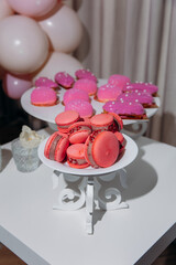 Festive table setting for a baby shower party with pink cupcake baking. Waiting for the birth of a girl