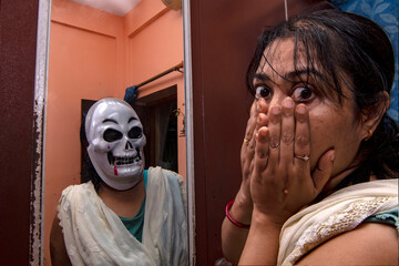 Young Woman's Skeleton Reflection in Mirror - Concept of Inner Devil and Horror