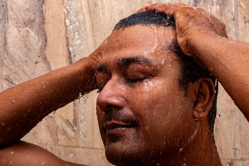 Young man enjoying a refreshing shower