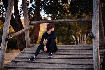 Obraz premium Woman relaxing outdoors on a wooden platform