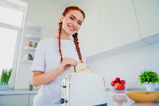 Photo of pretty cute girl cooking delicious breakfast toast white light interior kitchen room daylight indoors