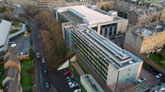 View of a modern office building in Edinburgh, surrounded by historic residential structures and narrow streets. Captures urban planning and contemporary and traditional architecture.