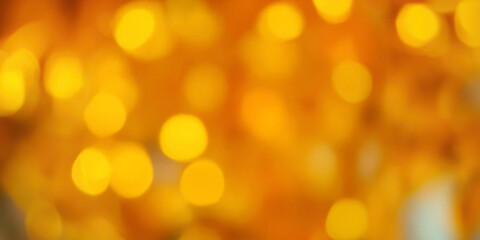 Obraz premium Vibrant golden bokeh lights creating a warm and festive atmosphere