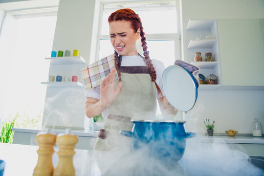 Photo of charming girl wearing apron cooking meal first time kitchen room home house day light indoors