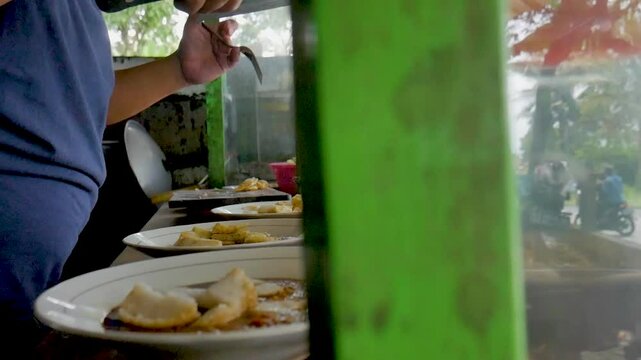 The process of making kupat tahu. Typical Indonesian food. Traders preparing food orders.