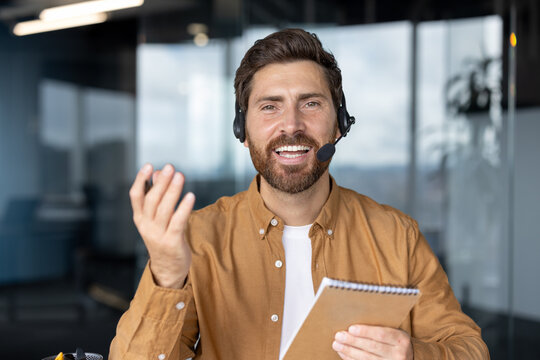 Business professional in virtual video call demonstrating communication skills. Engaging expression, wearing headset, holding notebook. Ideal for concepts of remote work, virtual meetings, technology