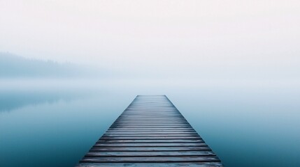 Fototapeta premium Serene reflection a misty morning over still waters and a wooden dock leading into the unknown