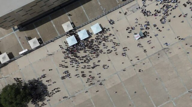 Aerial top down of crowd gathering near palasport arena before a sport event in Turin Italy