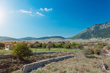 small village highland valley mountain environment space summer sun light day landmark landscape blue sky view