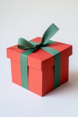 Obraz premium A bright red paper gift box with a green ribbon, sitting on a clean white background