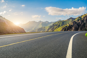 Asphalt road and green mountain with sky clouds natural landscape at sunset. road trip.