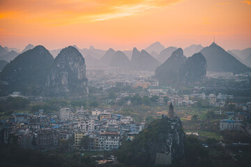 Sunset over the Guilin city surrounded by picturesque limestone mountains. Guilin, China, Copy space for text, aerial