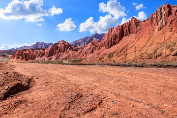 Dirt gravel road platform and Danxia landform mountain natural landscape under blue sky. car background.