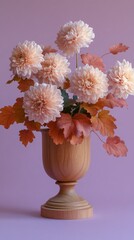 A graceful display of soft pink flowers in a wooden vase, complemented by autumn leaves, set against a gentle pastel pink background