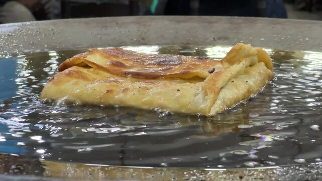 Mughlai paratha romanized Moglai is a Bengali street food of soft fried bread enhanced by a stuffing of keema minced meat, egg, onions and pepper.
