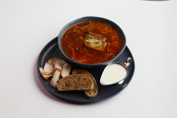 Traditional Ukrainian borscht . Bowl of red beetroot soup borscht with white cream and rye bread with lard. Beet Root delicious soup . Traditional Ukraine food cuisine