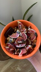 porridge bowl topped with figs, seeds and dark chocolate
