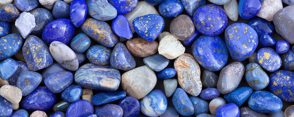 A large quantity of Lapis Lazuli stones layered in a visually appealing manner, filling the entire background