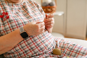 Close-up view of hands of an older woman crocheting