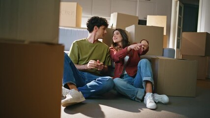 Property owners pair inspecting living room after moving relocation at new house