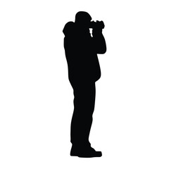 Silhouette of a man taking a photo with a camera